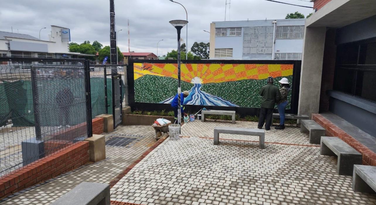 Completed public courtyard with paving, seating and mural